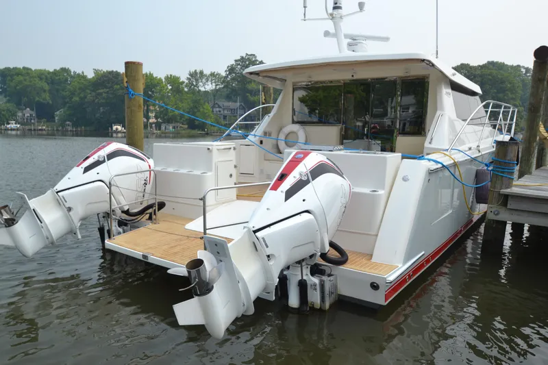 Slide: The Image of 2022 ArrowCat 42 Coupe docked with twin outboard engines. - 4
