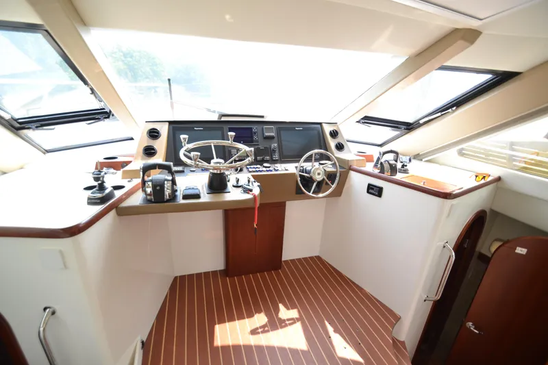 Slide: The Image of Interior helm of 2022 ArrowCat 42 Coupe with modern navigation equipment. - 9