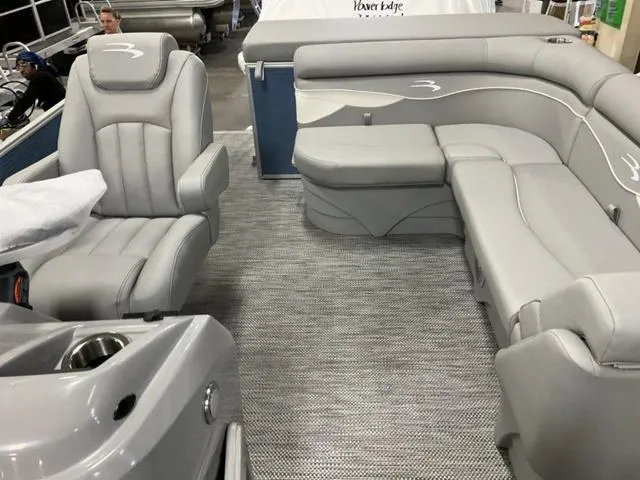Slide: The Image of 2024 Bennington 218 SL pontoon boat interior with luxurious gray seating. - 11