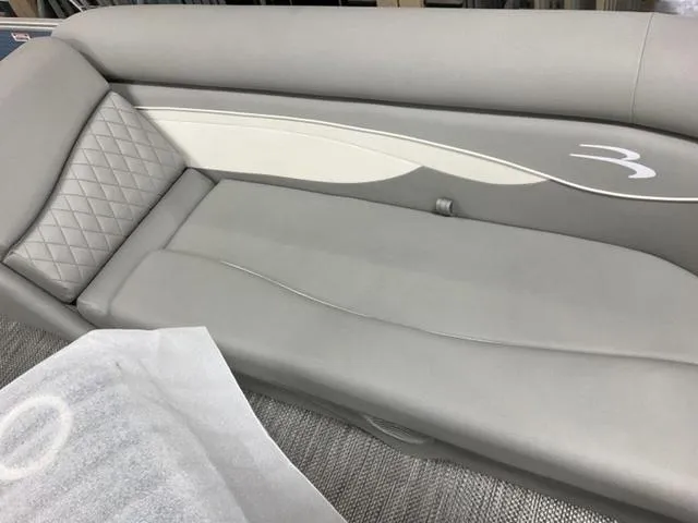 Slide: The Image of 2024 Bennington 218 SL boat interior with gray cushioned seating. - 14