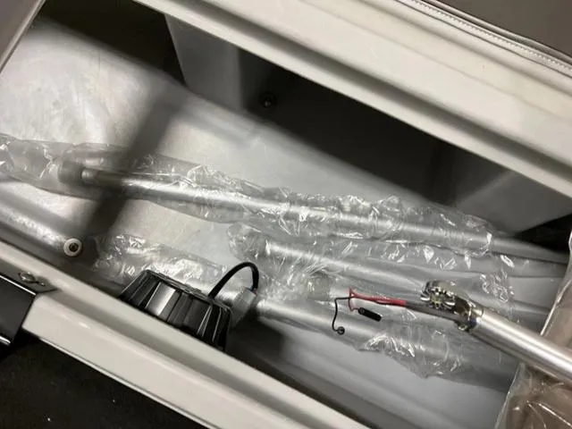 Slide: The Image of Storage compartment of 2024 Bennington 218 SL boat with fishing rods and accessories. - 16
