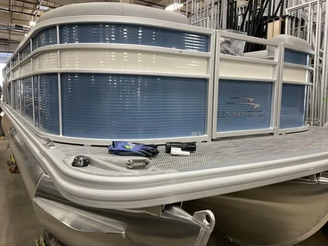 Slide: The Image of 2024 Bennington 218 SL pontoon boat in a warehouse. - 3