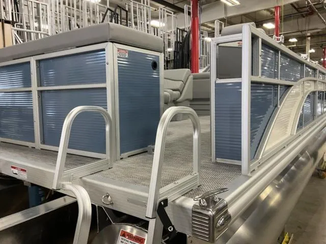 Slide: The Image of 2024 Bennington 218 SL pontoon boat in a showroom. - 4
