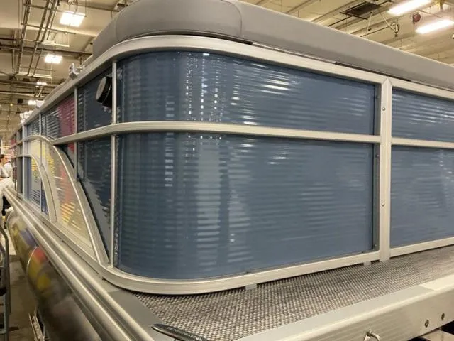 Slide: The Image of 2024 Bennington 218 SL pontoon boat in a showroom. - 6