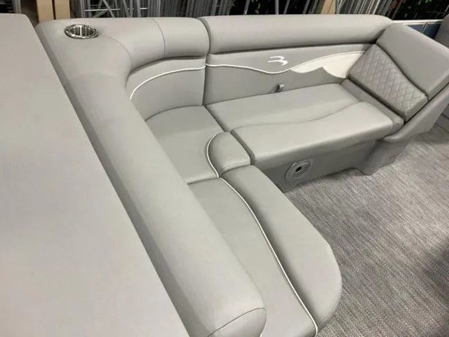 Slide: The Image of 2024 Bennington 218 SL boat interior with luxurious gray seating and cup holder. - 7