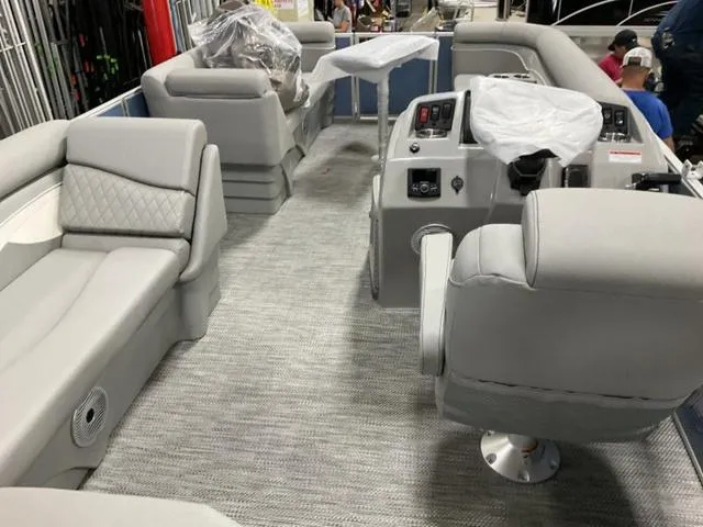 Slide: The Image of 2024 Bennington 218 SL pontoon boat interior with gray seating and modern controls. - 8