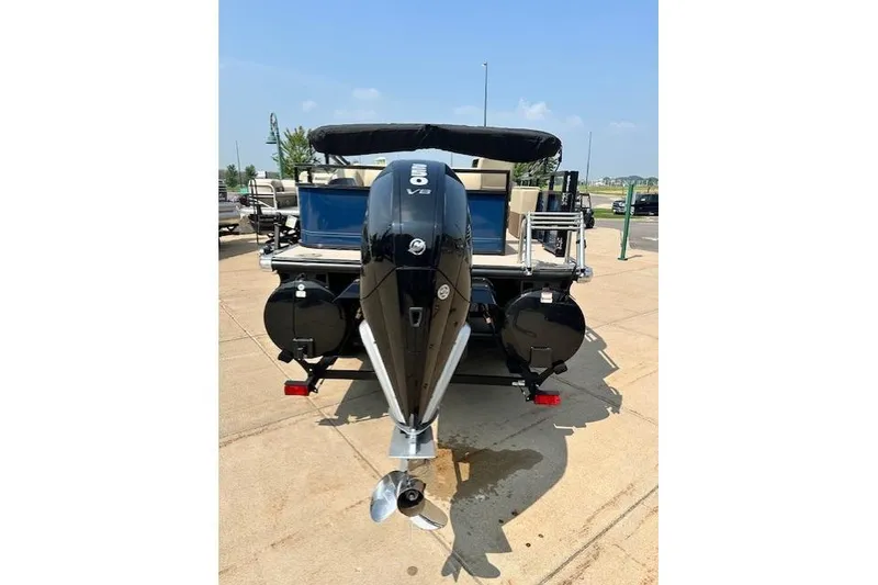 Slide: The Image of 2023 Regency 250 DL3 pontoon boat with powerful V8 engine, docked on a sunny day. - 3