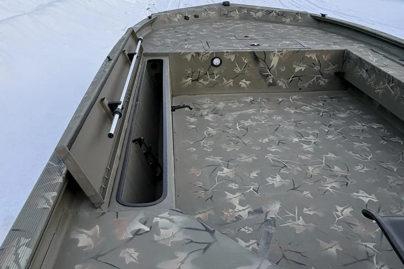 Slide: The Image of 2023 Tracker Grizzly 1654 T Sportsman boat with camouflage interior design. - 10