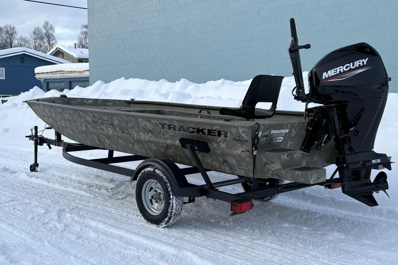 Slide: The Image of 2023 Tracker Grizzly 1654 T Sportsman boat with Mercury engine on snowy ground. - 7