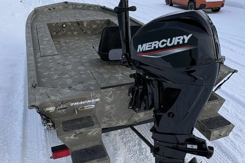 Slide: The Image of 2023 Tracker Grizzly 1654 T Sportsman boat with Mercury outboard motor on snowy ground. - 8