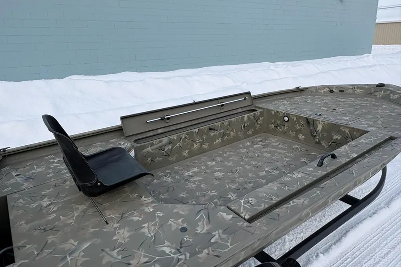 Slide: The Image of 2023 Tracker Grizzly 1654 T Sportsman boat with camouflage design, featuring a single seat. - 9