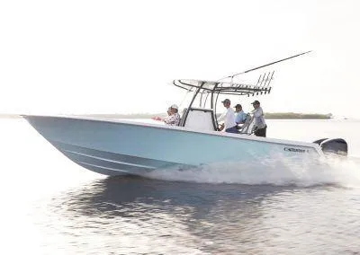 Slide: The Image of 2025 Contender 30 ST boat cruising on water with three passengers. - 1