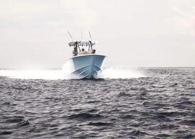 Slide: The Image of 2025 Contender 30 ST boat cruising on open water. - 2