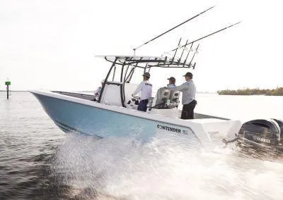 Slide: The Image of 2025 Contender 30 ST boat cruising on water with three people onboard. - 5