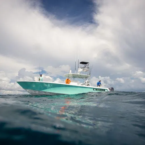 Slide: The Image of 2025 Contender 39ST boat on open water under cloudy sky. - 3