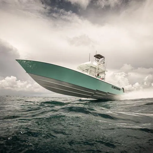 Slide: The Image of 2025 Contender 39ST boat cruising on open water under cloudy sky. - 4