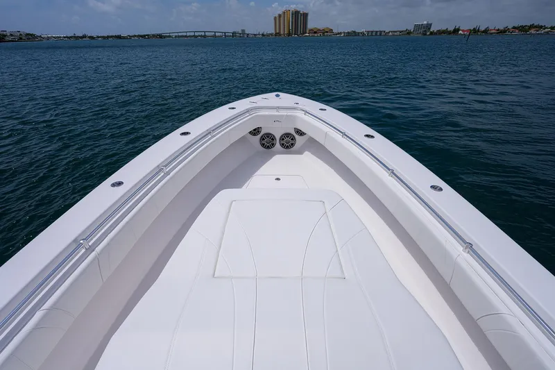 Slide: The Image of Bow view of 2025 Contender 39FA boat on calm water. - 10