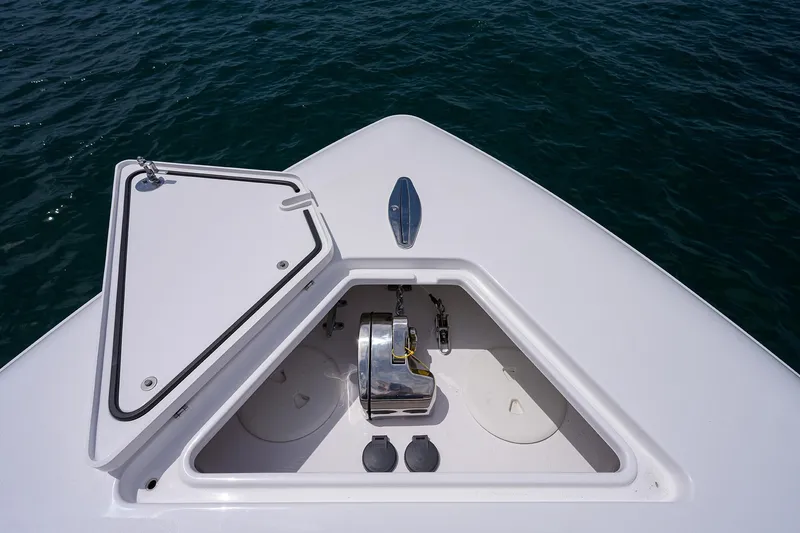 Slide: The Image of Contender 39FA 2025 boat anchor locker with open hatch, showing anchor mechanism and storage. - 11