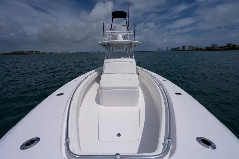 Slide: The Image of 2025 Contender 39FA boat on open water with clear sky. - 12