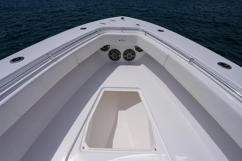 Slide: The Image of Contender 39FA 2025 boat bow with seating and storage compartment on the water. - 13