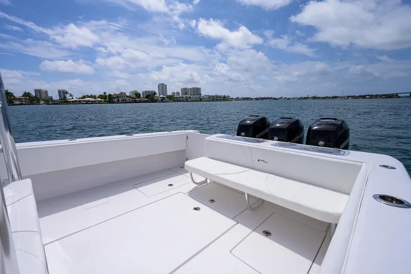 Slide: The Image of Contender 39FA 2025 boat with triple outboard engines on a sunny day. - 18