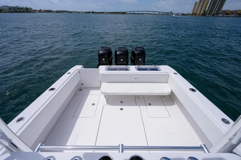Slide: The Image of Contender 39FA 2025 model boat with triple outboard engines on open water. - 19