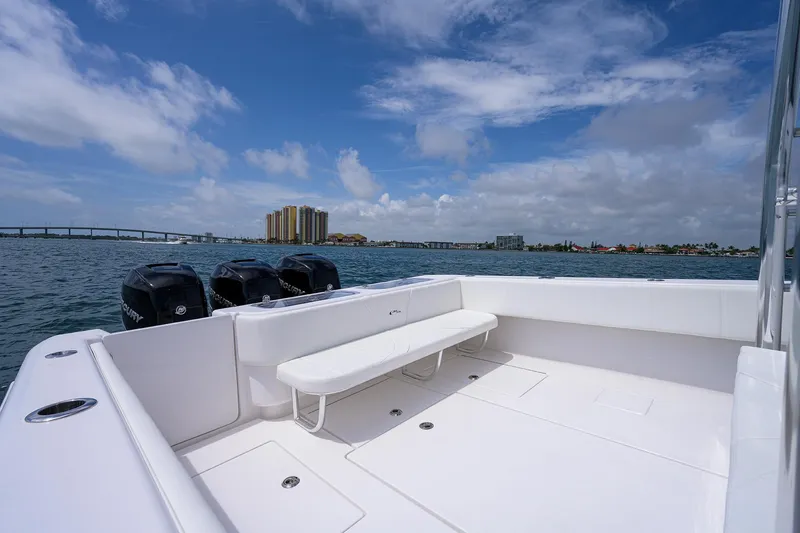 Slide: The Image of Contender 39FA 2025 boat with triple Mercury engines on a sunny day. - 20