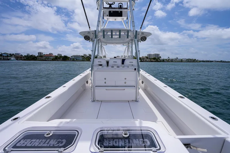 Slide: The Image of Contender 39FA 2025 model boat on water with clear sky and coastal background. - 22