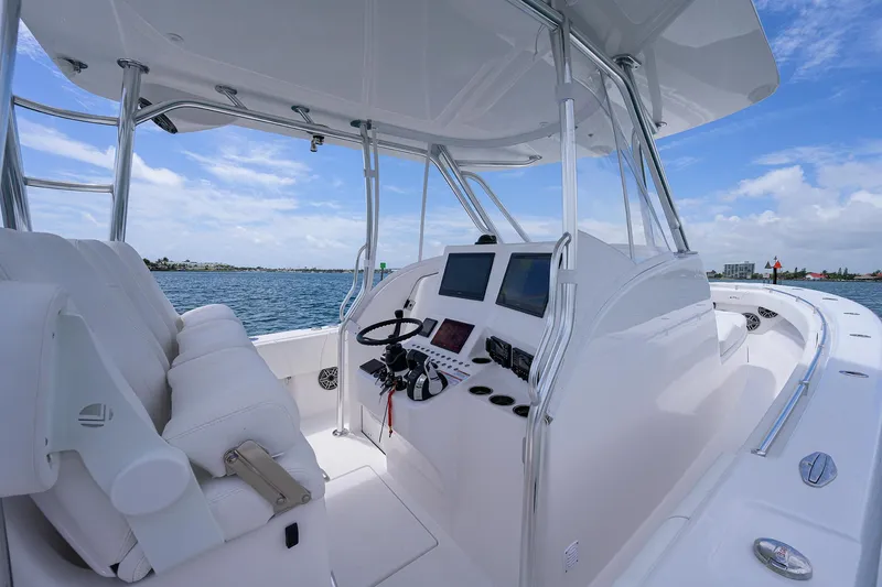 Slide: The Image of Contender 39FA 2025 boat cockpit with modern controls and ocean view. - 28