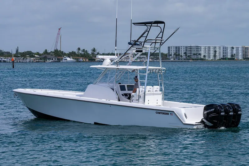 Slide: The Image of 2025 Contender 39FA boat cruising on water with triple Mercury 400 engines. - 3