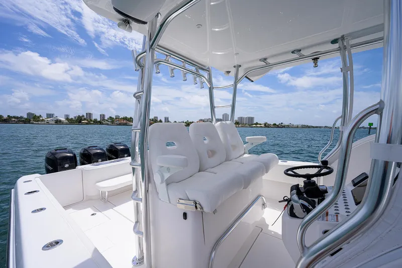 Slide: The Image of Contender 39FA 2025 model boat interior with white seating and multiple outboard engines. - 30