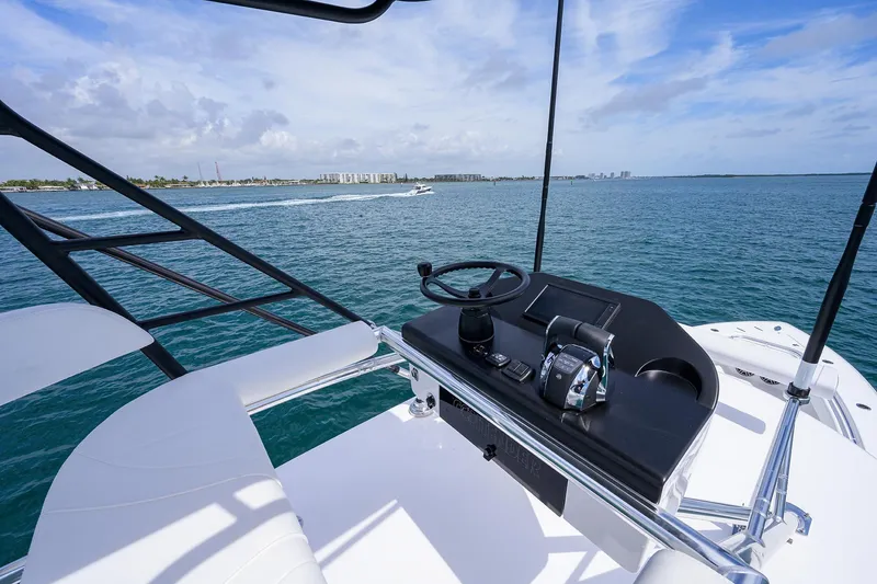 Slide: The Image of Contender 39FA 2025 boat helm station with ocean view and distant shoreline. - 31