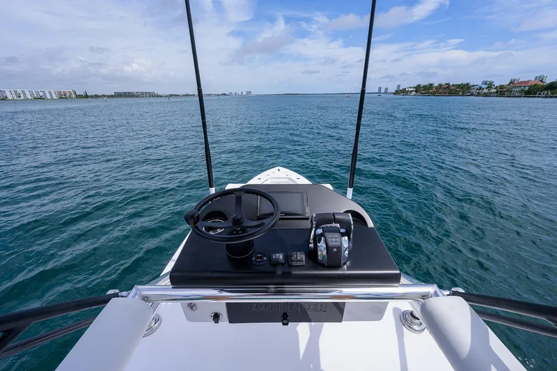 Slide: The Image of View from the helm of a 2025 Contender 39FA boat on open water. - 32