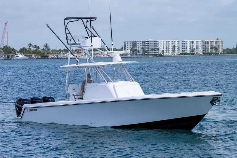 Slide: The Image of 2025 Contender 39FA boat cruising on water near coastal buildings. - 4