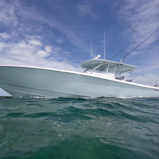 Slide: The Image of 2025 Contender 44FA boat on open water under a blue sky. - 10