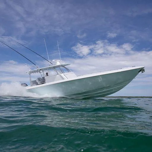 Slide: The Image of 2025 Contender 44FA boat cruising on open water under a clear blue sky. - 11