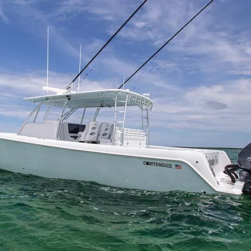 Slide: The Image of 2025 Contender 44FA boat on open water under clear sky. - 13