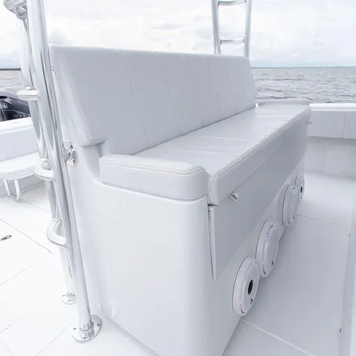 Slide: The Image of Contender 44FA 2025 boat with white cushioned seating and ocean backdrop. - 14