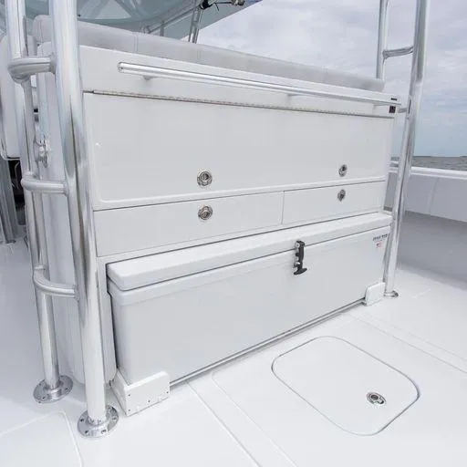 Slide: The Image of Contender 44FA 2025 boat storage compartments and cooler on deck. - 16