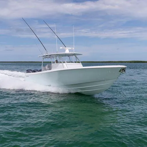 Slide: The Image of 2025 Contender 44FA boat cruising on open water with fishing rods. - 2