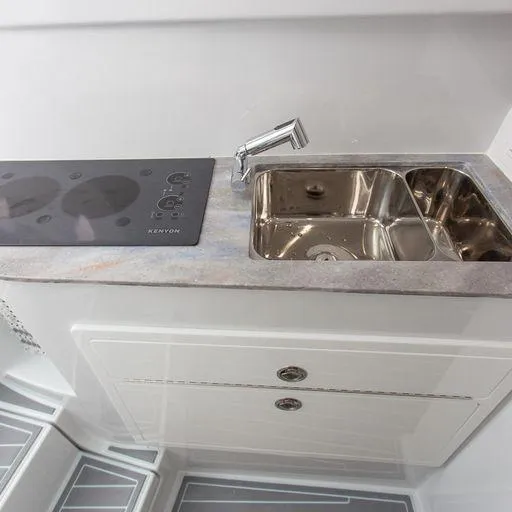 Slide: The Image of Contender 44FA 2025 boat kitchen with sink and stovetop. - 20