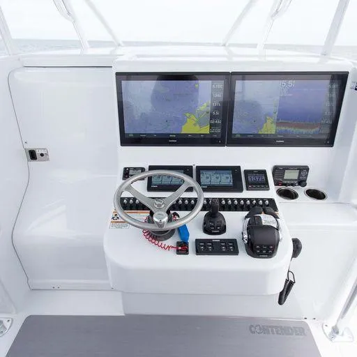 Slide: The Image of Contender 44FA 2025 boat dashboard with dual navigation screens and control panel. - 22