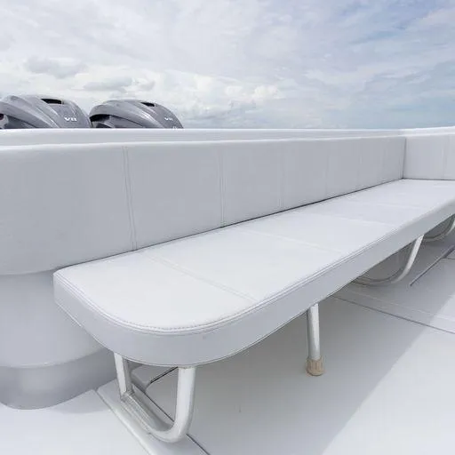 Slide: The Image of Contender 44FA 2025 model boat with white cushioned seating and twin outboard motors. - 23