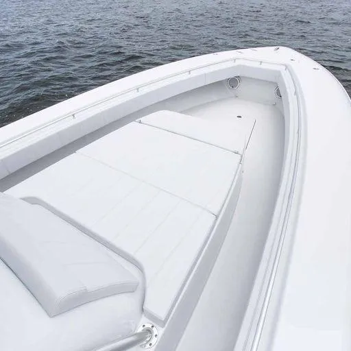 Slide: The Image of Contender 44FA 2025 boat with spacious white deck and seating area on the water. - 24