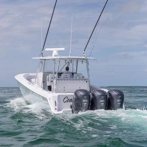 Slide: The Image of 2025 Contender 44FA boat with triple 425 V8 engines cruising on the ocean. - 7