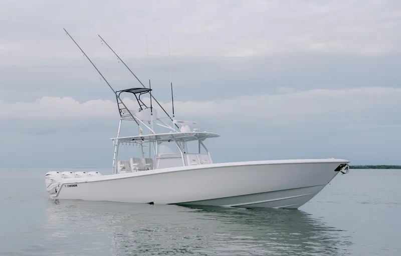Slide: The Image of 2025 Contender 44CB boat on calm water under cloudy sky. - 3