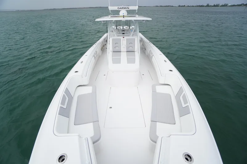 Slide: The Image of 2025 Contender 44CB boat with spacious deck and seating on open water. - 6