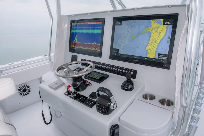 Slide: The Image of Contender 44CB 2025 boat dashboard with navigation and sonar screens. - 7
