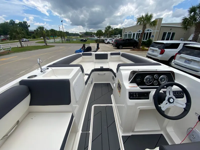 Slide: The Image of 2022 Bayliner DX2000 boat interior with steering wheel and seating. - 13
