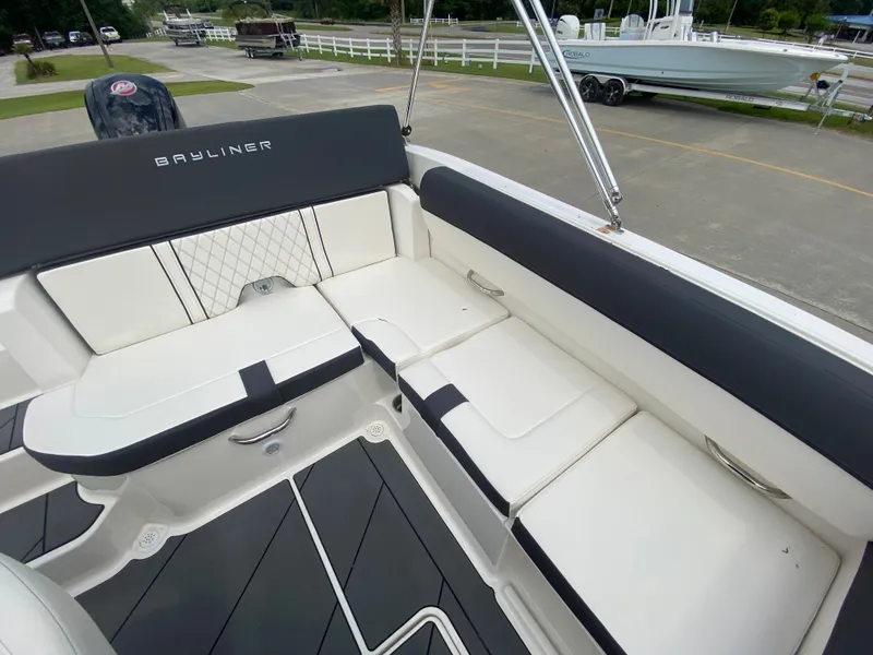 Slide: The Image of 2022 Bayliner DX2000 boat interior with cushioned seating and modern design. - 21